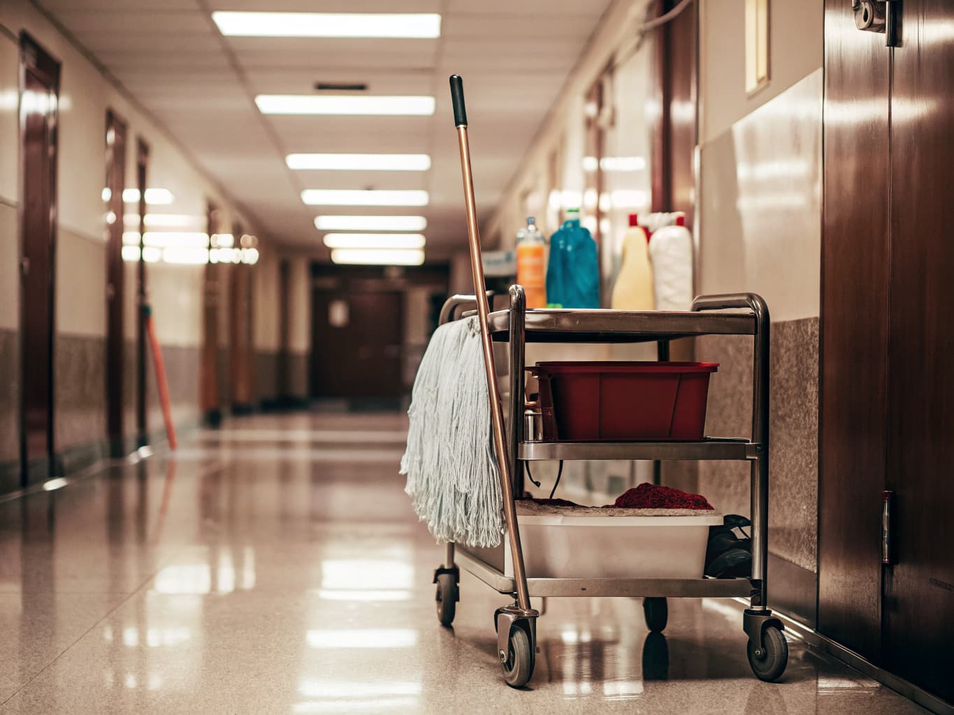 Janitorial cleaning cart in office corridor